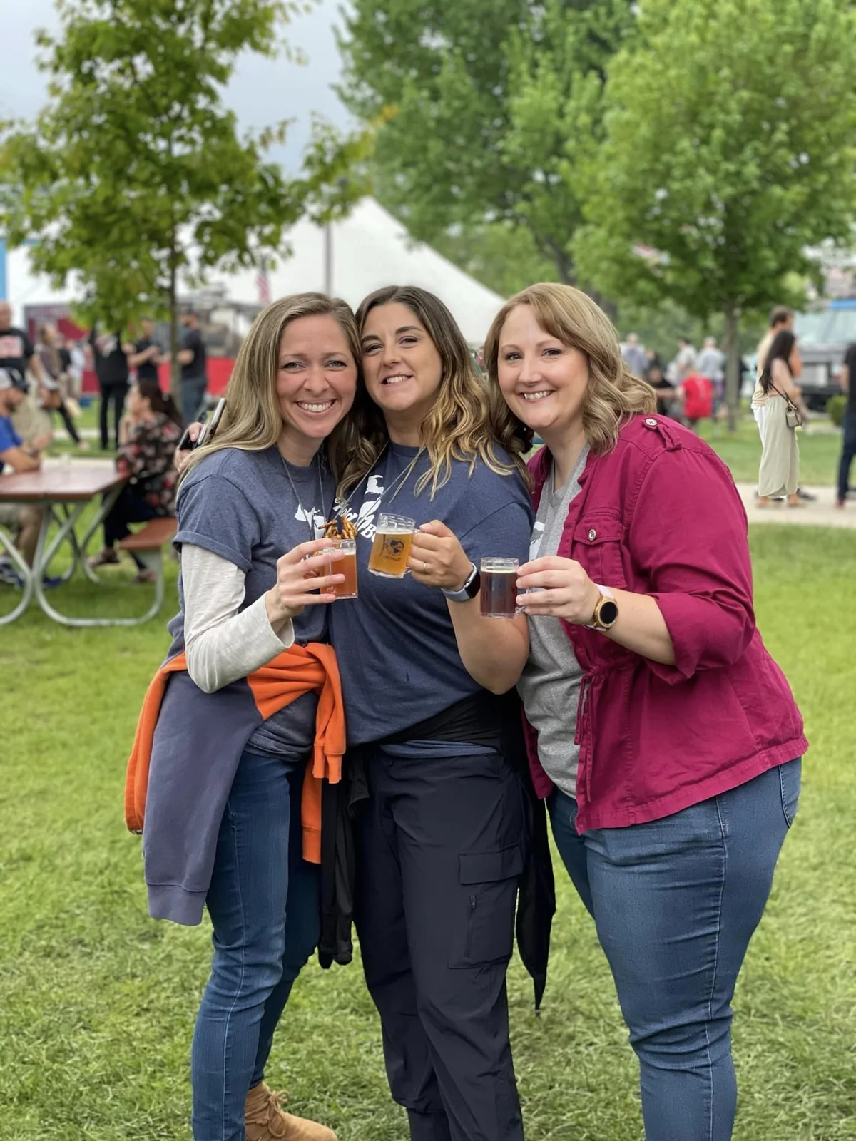 Three friends enjoying World Expo of Beer together outdoors